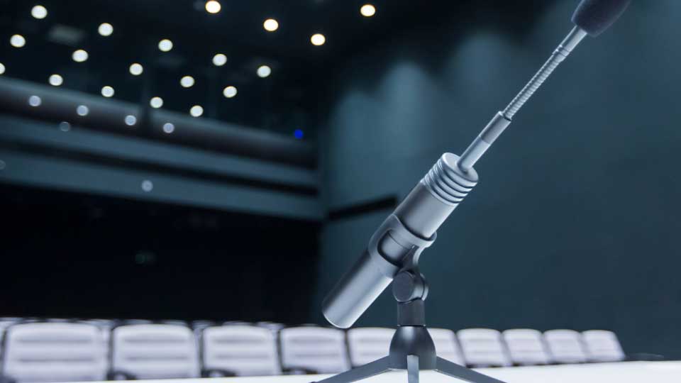 Microphone with empty stage in the background