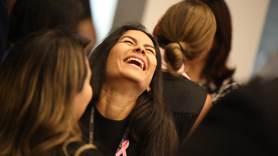 Estée Lauder attendee genuinely connecting at corporate event showing feeling-first design results