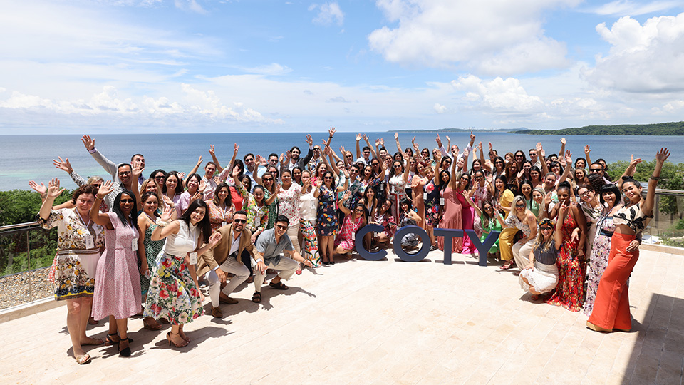 COTY team celebrating at beachside corporate event demonstrating connection as designed outcome