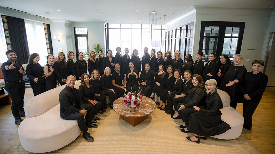 Dior team group photo in elegant setting showcasing the plus one emotional design element