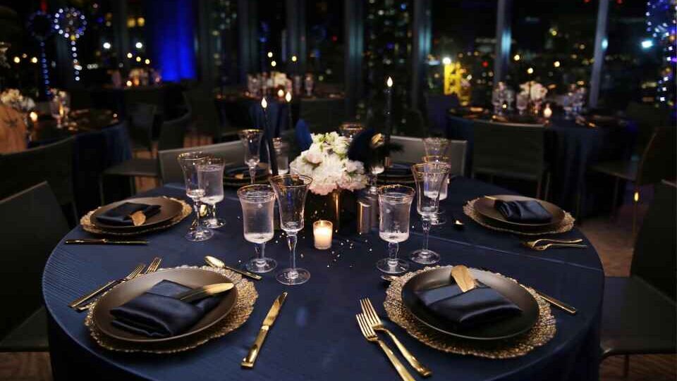Elegant navy and gold table setting for corporate year-end celebration event