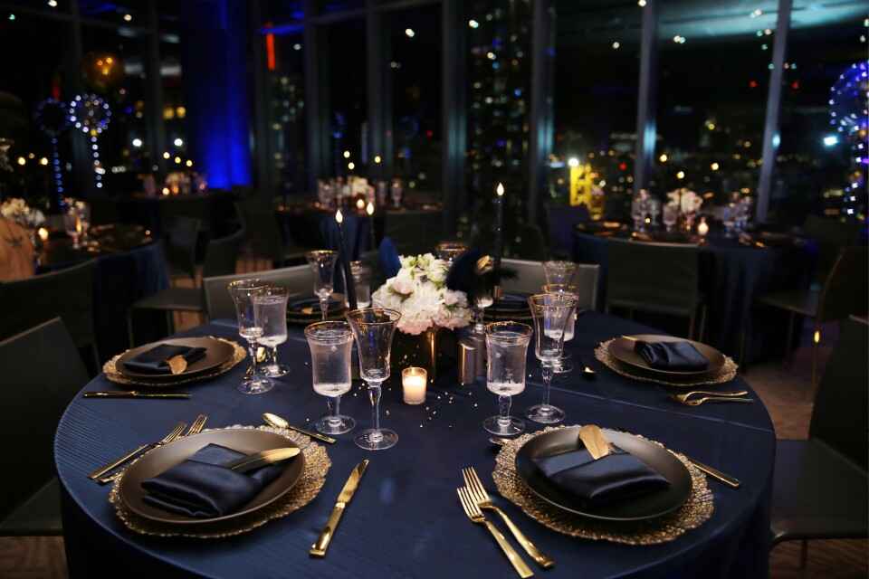 Elegant navy and gold table setting for corporate year-end celebration event